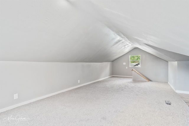 2383 Julia St, Bossier City, LA 71112 - bonus room with baseboards, vaulted ceiling, and carpet