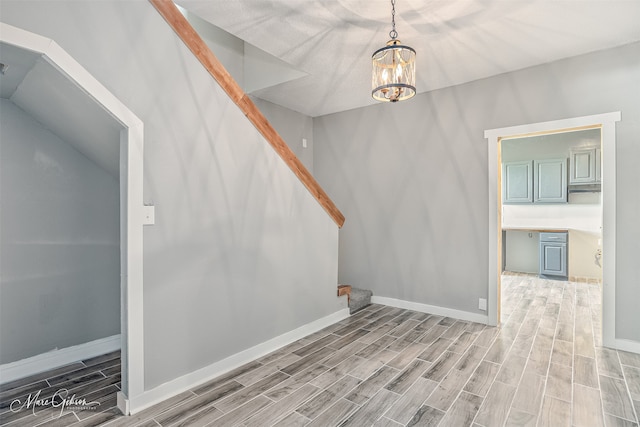 2383 Julia St, Bossier City, LA 71112 - interior space with wood tiled floors, stairs, baseboards, and a chandelier