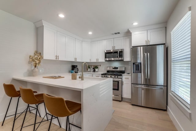 1614 Engle Ave, Dallas, TX 75224 - kitchen featuring stainless steel appliances, a sink, a peninsula, plenty of natural light, and recessed lighting