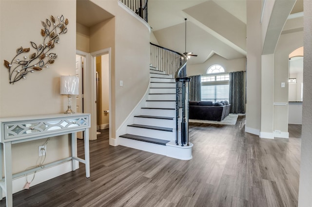 2828 Pino, Grand Prairie, TX 75054 - staircase with wood finished floors, arched walkways, high vaulted ceiling, and ceiling fan
