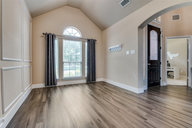 2828 Pino, Grand Prairie, TX 75054 - unfurnished room featuring arched walkways, wood finished floors, and lofted ceiling