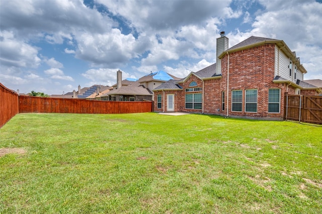 2828 Pino, Grand Prairie, TX 75054 - back of house with brick siding, a fenced backyard, and a chimney