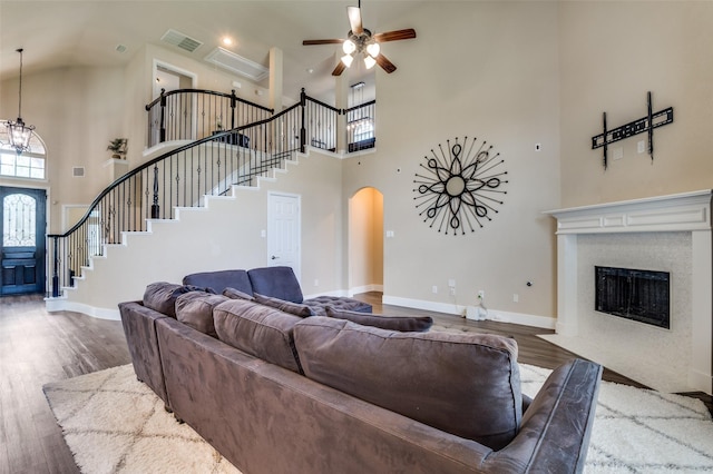 2828 Pino, Grand Prairie, TX 75054 - living room featuring a high ceiling, stairway, arched walkways, ceiling fan, and wood finished floors