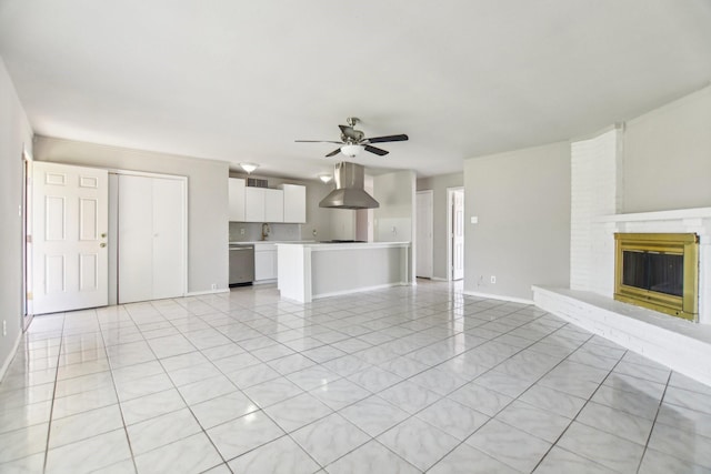5001 N Colony Blvd, The Colony, TX 75056 - unfurnished living room featuring a ceiling fan, baseboards, light tile patterned floors, a fireplace, and a sink