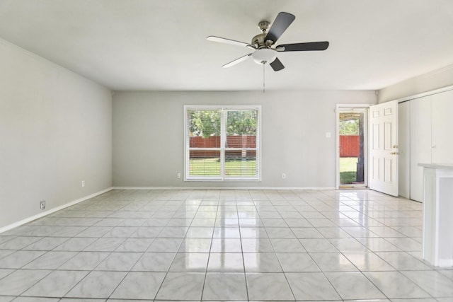 5001 N Colony Blvd, The Colony, TX 75056 - empty room with light tile patterned floors, a ceiling fan, and baseboards