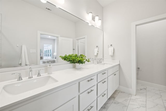 1028 Cavour Pl, Dallas, TX 75204 - ensuite bathroom featuring double vanity and marble look tiles