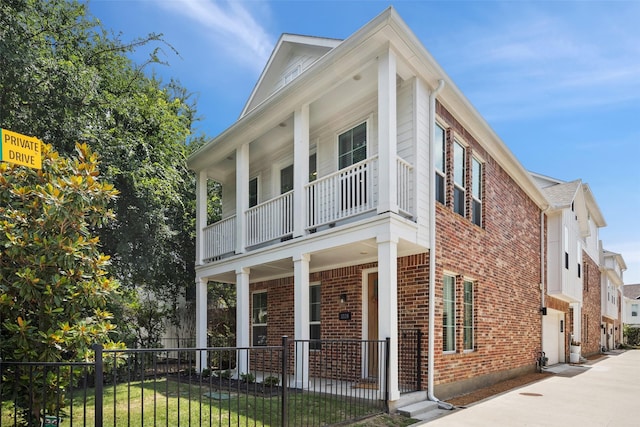 1028 Cavour Pl, Dallas, TX 75204 - view of side of property featuring a porch, a balcony, brick siding, a garage, and driveway