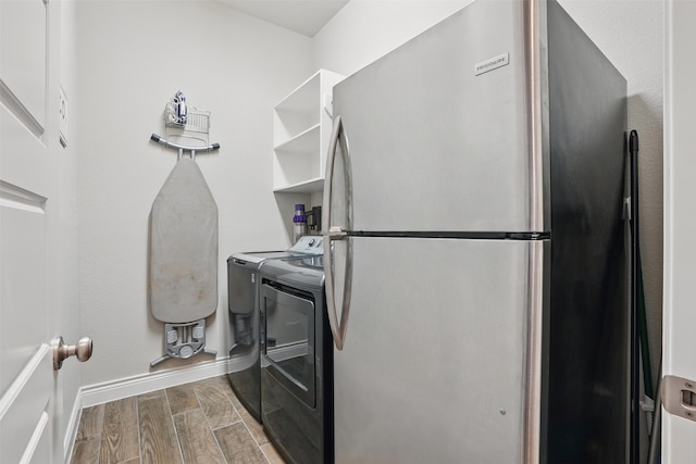 3904 Purple Sage Dr, Aubrey, TX 76227 - washroom with washing machine and clothes dryer, wood tiled floors, and baseboards