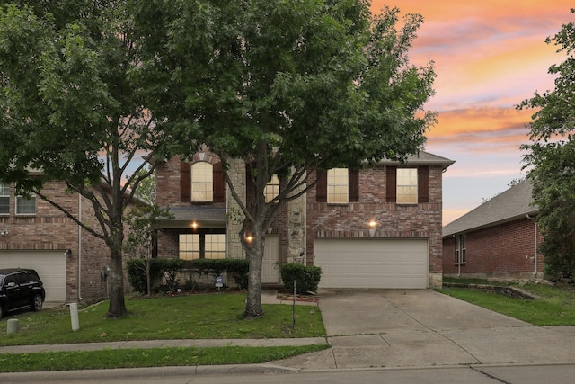 9897 Dartmouth Dr, Frisco, TX 75035 - view of front of house featuring a garage, concrete driveway, a front yard, and brick siding