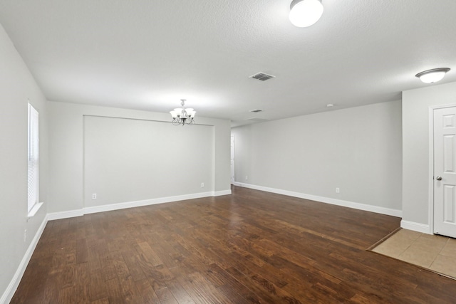9897 Dartmouth Dr, Frisco, TX 75035 - unfurnished room featuring hardwood / wood-style flooring, a chandelier, and baseboards