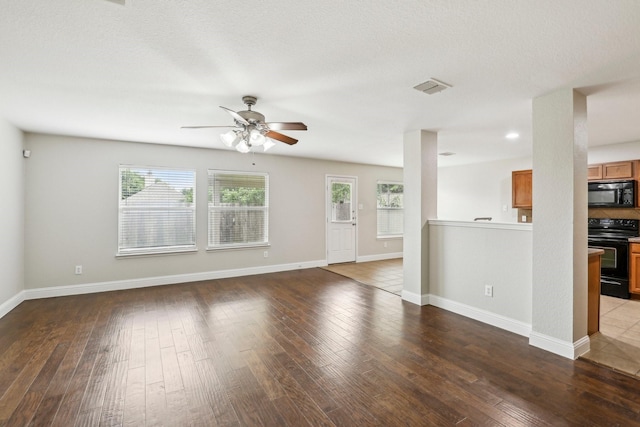 9897 Dartmouth Dr, Frisco, TX 75035 - unfurnished living room with plenty of natural light, ceiling fan, wood-type flooring, and baseboards