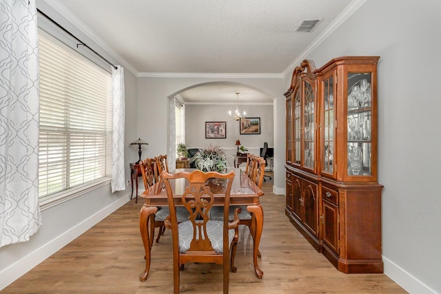 1304 Waterdown Dr, Allen, TX 75013 - dining space featuring arched walkways, plenty of natural light, a chandelier, baseboards, and crown molding
