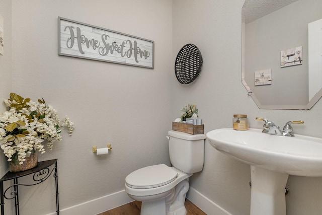 1304 Waterdown Dr, Allen, TX 75013 - half bathroom with wood finished floors, toilet, baseboards, and a sink