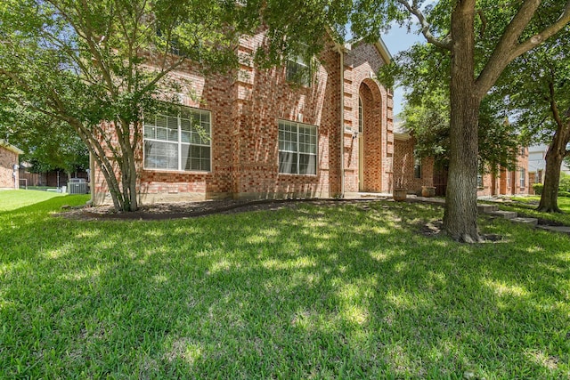 1304 Waterdown Dr, Allen, TX 75013 - view of front of house featuring brick siding, a front yard, and central AC unit