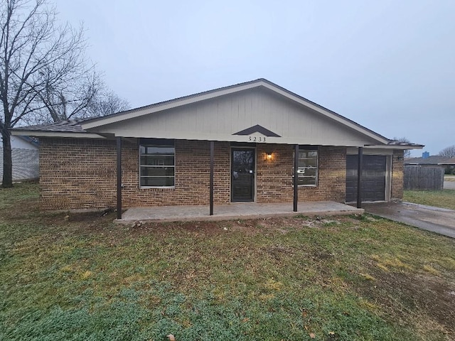5233 Kingston Ct, Abilene, TX 79605 - view of front facade featuring brick siding, concrete driveway, a front yard, and a garage