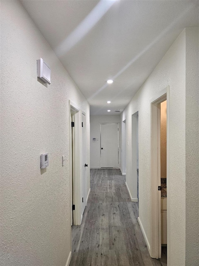 5233 Kingston Ct, Abilene, TX 79605 - hallway featuring a textured wall, wood finished floors, recessed lighting, and baseboards