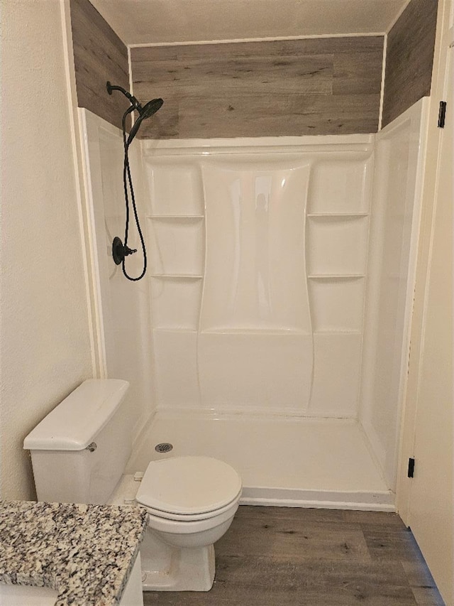 5233 Kingston Ct, Abilene, TX 79605 - full bath featuring toilet, a stall shower, wood finished floors, and vanity
