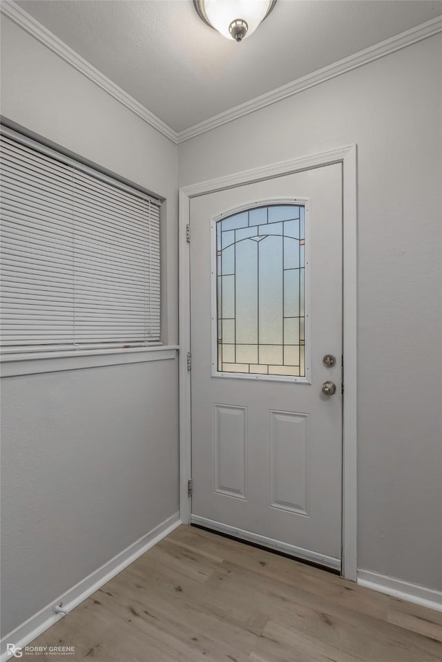 3238 Schuler Dr, Bossier City, LA 71112 - doorway featuring crown molding, wood finished floors, and baseboards