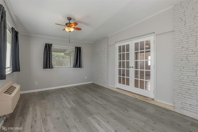3238 Schuler Dr, Bossier City, LA 71112 - spare room with french doors, ceiling fan, a wall mounted air conditioner, crown molding, and wood finished floors