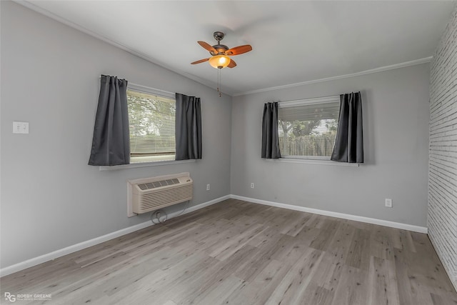 3238 Schuler Dr, Bossier City, LA 71112 - unfurnished room with a wall unit AC, healthy amount of natural light, ornamental molding, wood finished floors, and baseboards