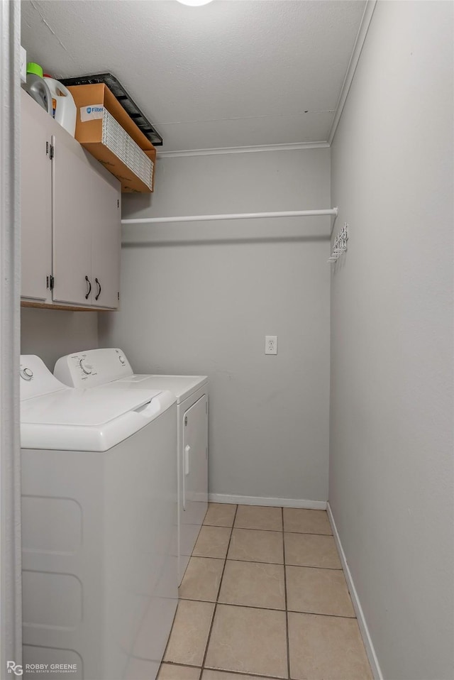 3238 Schuler Dr, Bossier City, LA 71112 - laundry room with cabinet space, washer and clothes dryer, light tile patterned flooring, ornamental molding, and baseboards