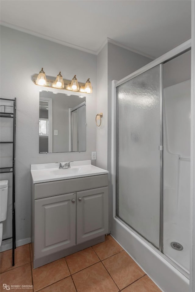3238 Schuler Dr, Bossier City, LA 71112 - bathroom with tile patterned floors, toilet, a shower stall, vanity, and ornamental molding