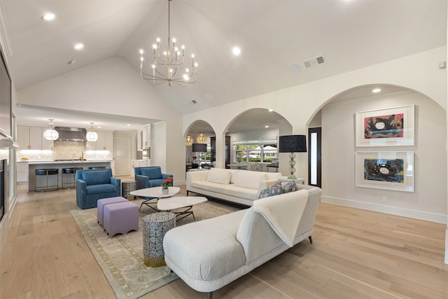 4016 Goodfellow Dr, Dallas, TX 75229 - living area with a chandelier, light wood-style floors, arched walkways, high vaulted ceiling, and recessed lighting