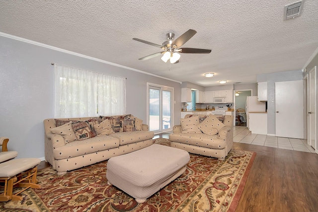 3929 Wrenwood Dr, Fort Worth, TX 76137 - living area featuring ceiling fan, ornamental molding, wood finished floors, and a textured ceiling