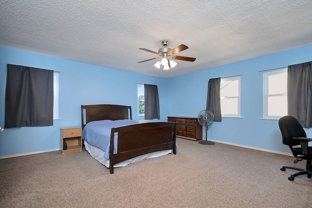 3929 Wrenwood Dr, Fort Worth, TX 76137 - carpeted bedroom featuring multiple windows, baseboards, a ceiling fan, and a textured ceiling