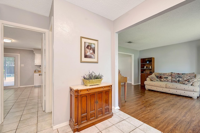 3929 Wrenwood Dr, Fort Worth, TX 76137 - hall with light tile patterned flooring, a textured ceiling, and baseboards