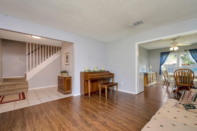 3929 Wrenwood Dr, Fort Worth, TX 76137 - living room featuring wood finished floors, stairway, ceiling fan, a textured ceiling, and baseboards