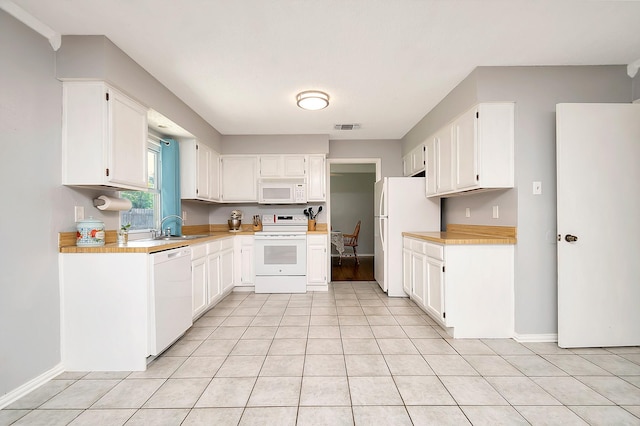 3929 Wrenwood Dr, Fort Worth, TX 76137 - kitchen featuring white appliances, a sink, light countertops, white cabinets, and baseboards