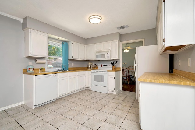 3929 Wrenwood Dr, Fort Worth, TX 76137 - kitchen featuring white appliances, white cabinets, light tile patterned flooring, a sink, and light countertops