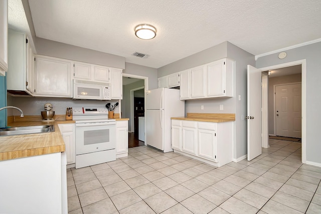 3929 Wrenwood Dr, Fort Worth, TX 76137 - kitchen with white appliances, a sink, white cabinetry, light tile patterned flooring, and a textured ceiling