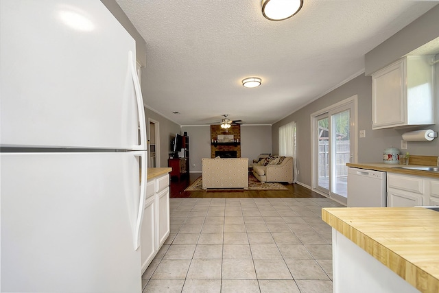 3929 Wrenwood Dr, Fort Worth, TX 76137 - kitchen featuring white appliances, butcher block counters, a ceiling fan, white cabinetry, and crown molding