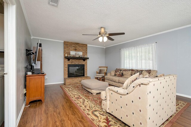 3929 Wrenwood Dr, Fort Worth, TX 76137 - living area featuring a ceiling fan, wood finished floors, crown molding, a fireplace, and baseboards