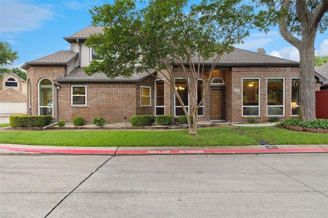 422 Arbor Creek Dr, Euless, TX 76039 - view of front of house featuring roof with shingles, brick siding, a front lawn, and a chimney