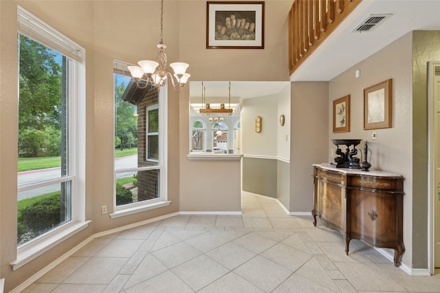422 Arbor Creek Dr, Euless, TX 76039 - unfurnished dining area featuring a chandelier, baseboards, light tile patterned floors, a towering ceiling, and healthy amount of natural light