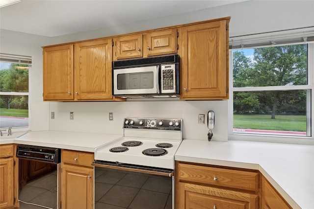 422 Arbor Creek Dr, Euless, TX 76039 - kitchen featuring stainless steel microwave, electric range, dishwasher, light countertops, and tile patterned floors
