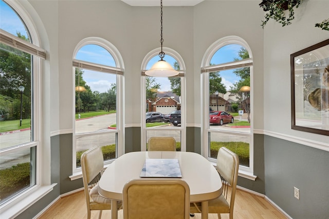 422 Arbor Creek Dr, Euless, TX 76039 - dining area featuring healthy amount of natural light, light wood-style flooring, a high ceiling, and baseboards