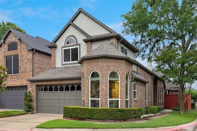 422 Arbor Creek Dr, Euless, TX 76039 - french country style house with a garage, brick siding, roof with shingles, stucco siding, and driveway