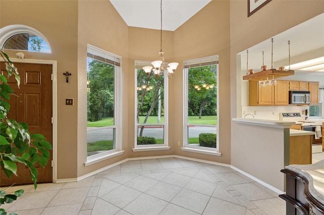 422 Arbor Creek Dr, Euless, TX 76039 - kitchen featuring stainless steel microwave, white range with electric cooktop, light tile patterned flooring, high vaulted ceiling, and light countertops