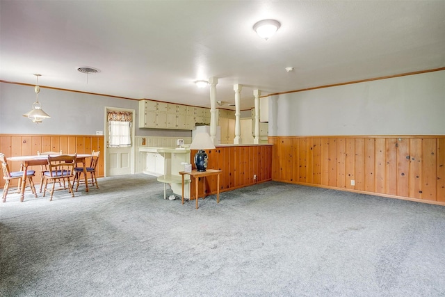4524 Morris Ct, Fort Worth, TX 76103 - living room with a wainscoted wall, carpet floors, wooden walls, and ornamental molding