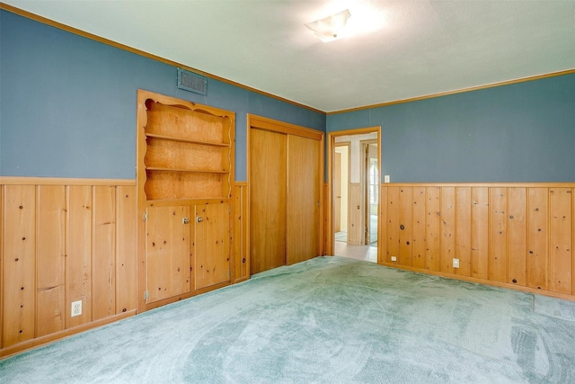 4524 Morris Ct, Fort Worth, TX 76103 - unfurnished bedroom with wainscoting, carpet flooring, a closet, wooden walls, and crown molding