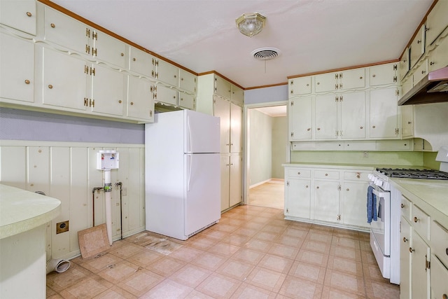 4524 Morris Ct, Fort Worth, TX 76103 - kitchen with white appliances, light floors, light countertops, and white cabinets