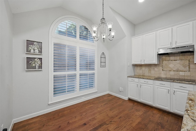 1325 Capstan Dr, Allen, TX 75013 - kitchen featuring under cabinet range hood, a chandelier, light stone counters, lofted ceiling, and black electric stovetop