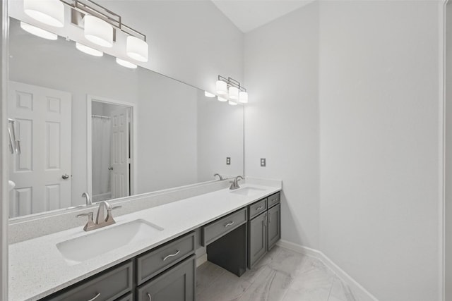 1325 Capstan Dr, Allen, TX 75013 - full bath with double vanity, marble finish flooring, and baseboards