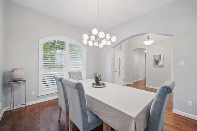 1325 Capstan Dr, Allen, TX 75013 - dining area featuring arched walkways, wood finished floors, a chandelier, and baseboards