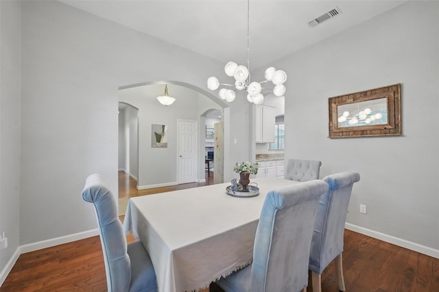 1325 Capstan Dr, Allen, TX 75013 - dining area with arched walkways, wood finished floors, baseboards, and a chandelier