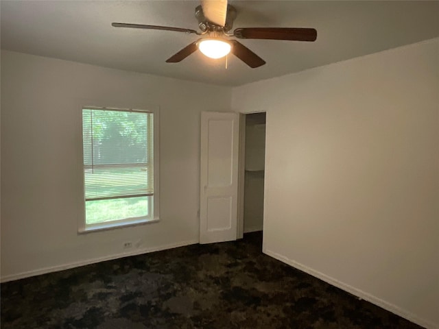 207 Bellview St, Sulphur Springs, TX 75482 - spare room featuring dark colored carpet, a ceiling fan, and baseboards